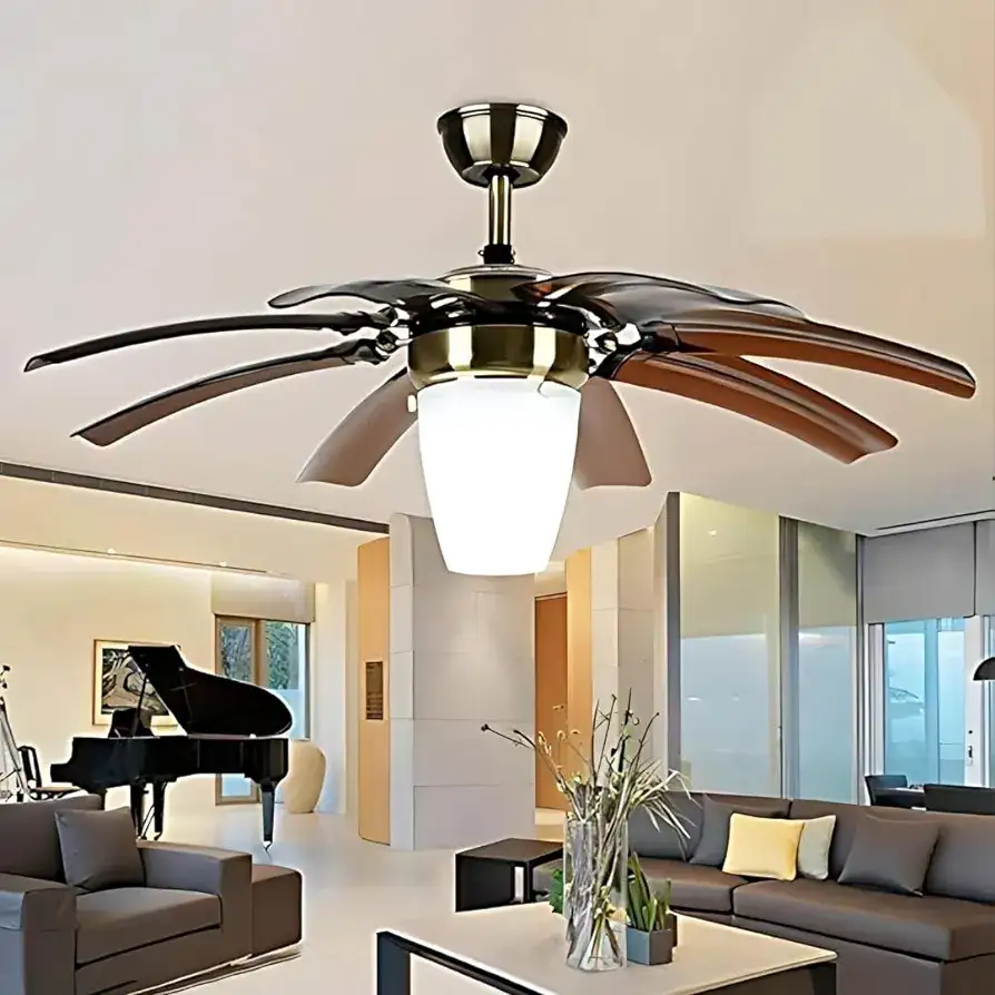 Modern living room with a stylish ceiling fan light fixture, brown sofa, glass table with a vase, and a grand piano in the background.