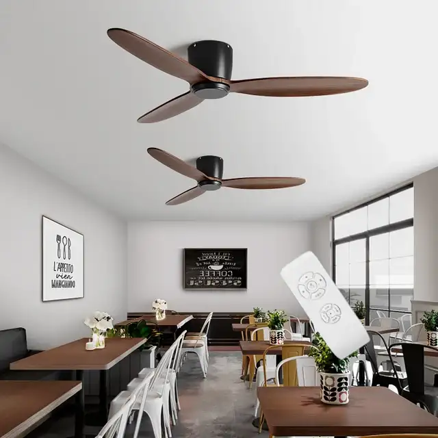 Modern cafe interior with wooden tables, white chairs, ceiling fans with wooden blades, and remote control.