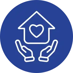 Blue circle with white icon of a house with a heart in the center, held by two hands, symbolizing care or support.