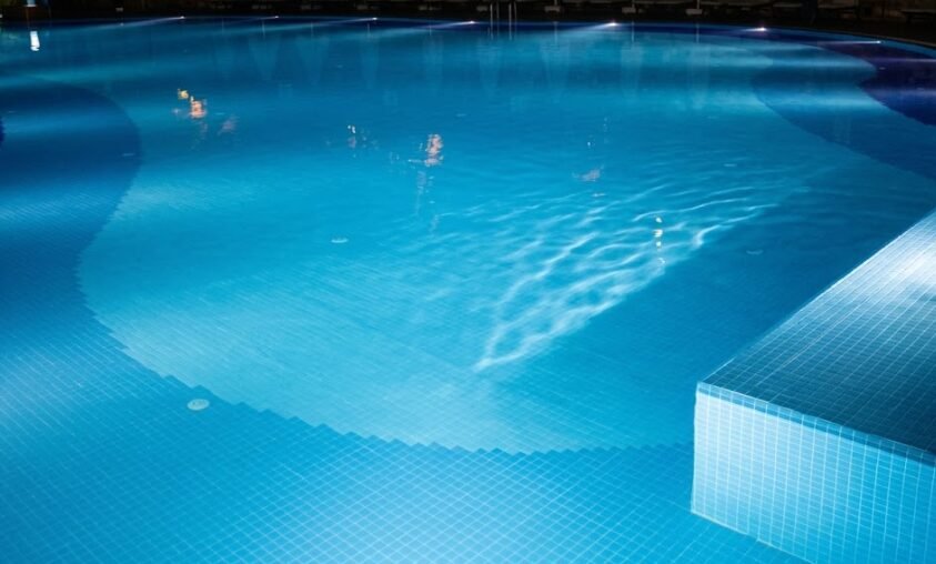Licensed pool electrician inspecting pool equipment at a Tweed Heads backyard property