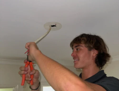 Blue Ridge electrician installing a ceiling light in a Banora Point home
